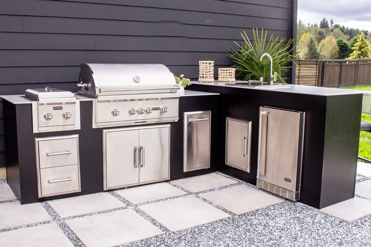black modular outdoor kitchen with sink and refrigerator