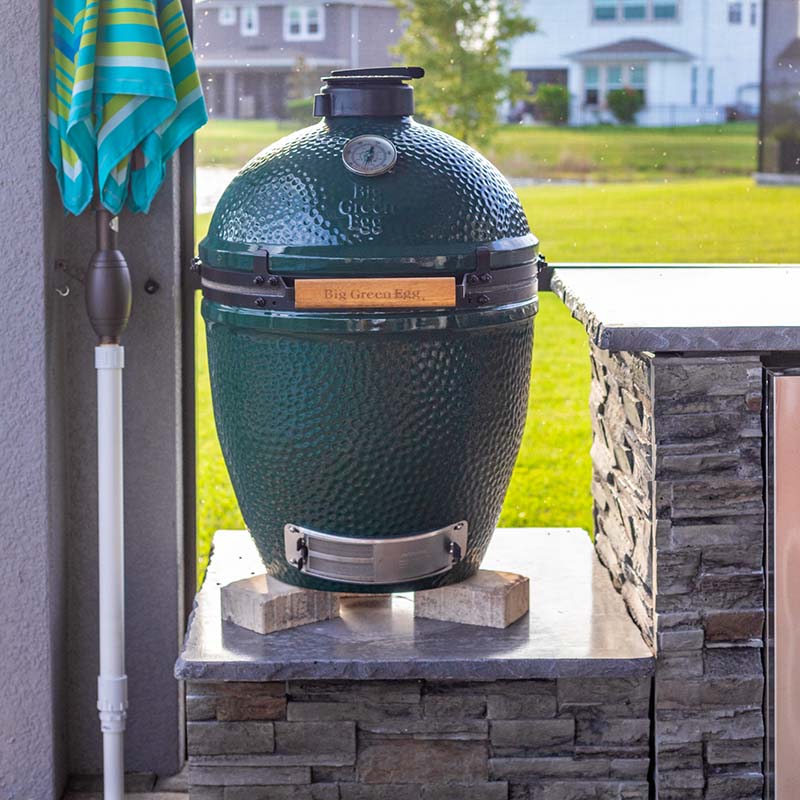 a big green egg kamodo cooker sitting on an rta outdoor kitchen
