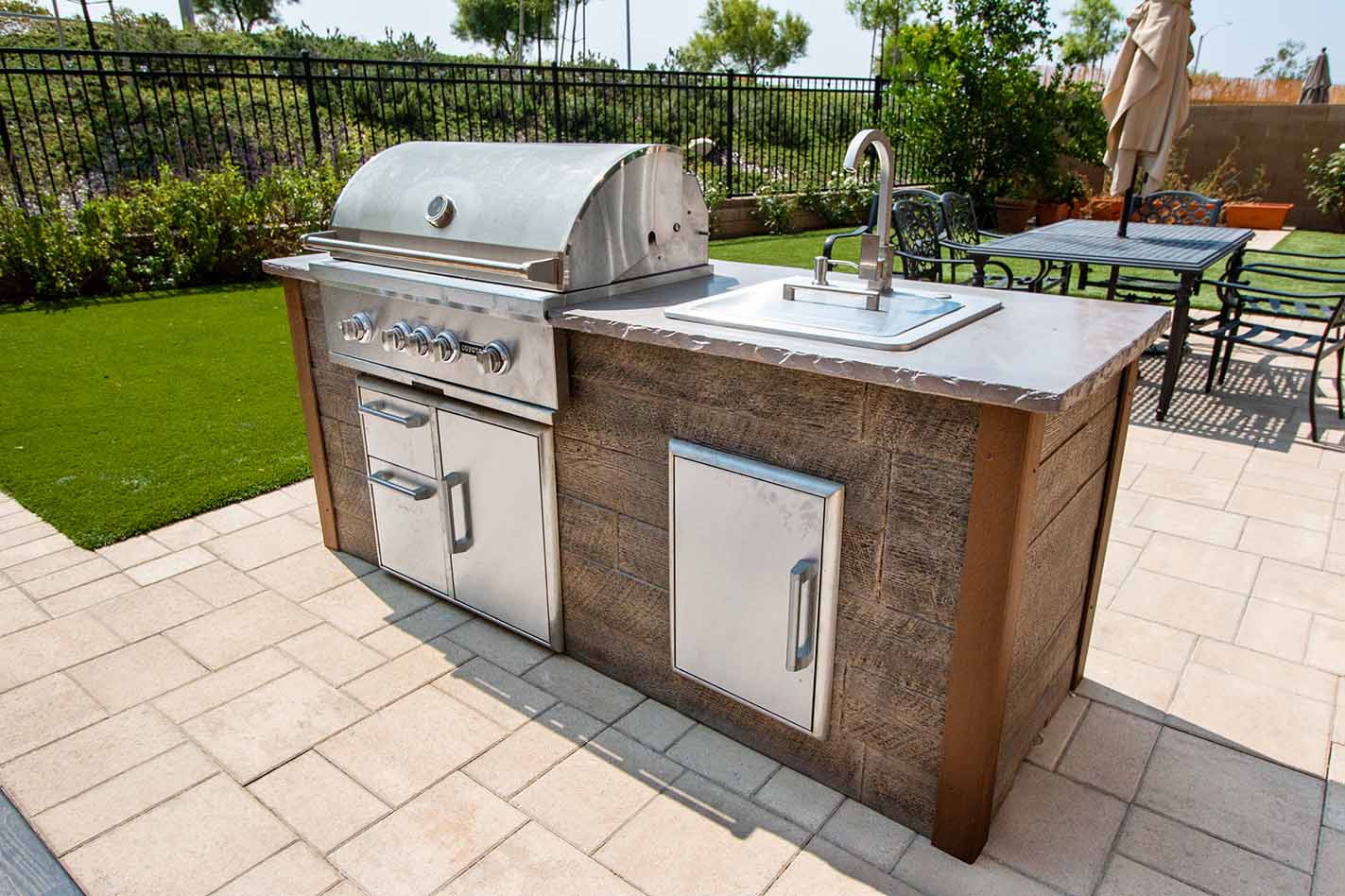 a simple small outdoor kitchen design with sink installed on a patio