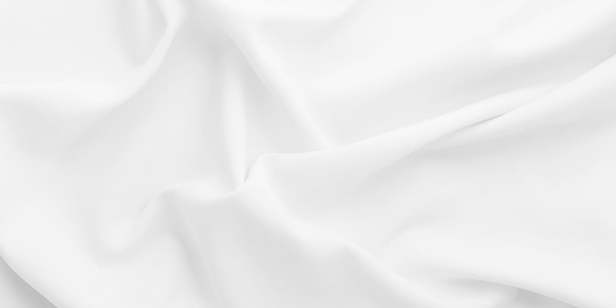 a white fabric bunched up ready to be used for outdoor kitchen roof structure