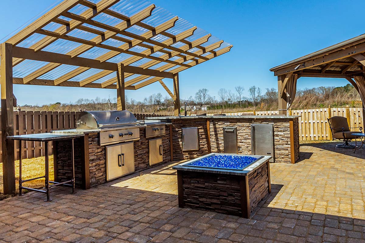 an l shape rta outdoor kitchen on paver patio with multiple coyote appliances