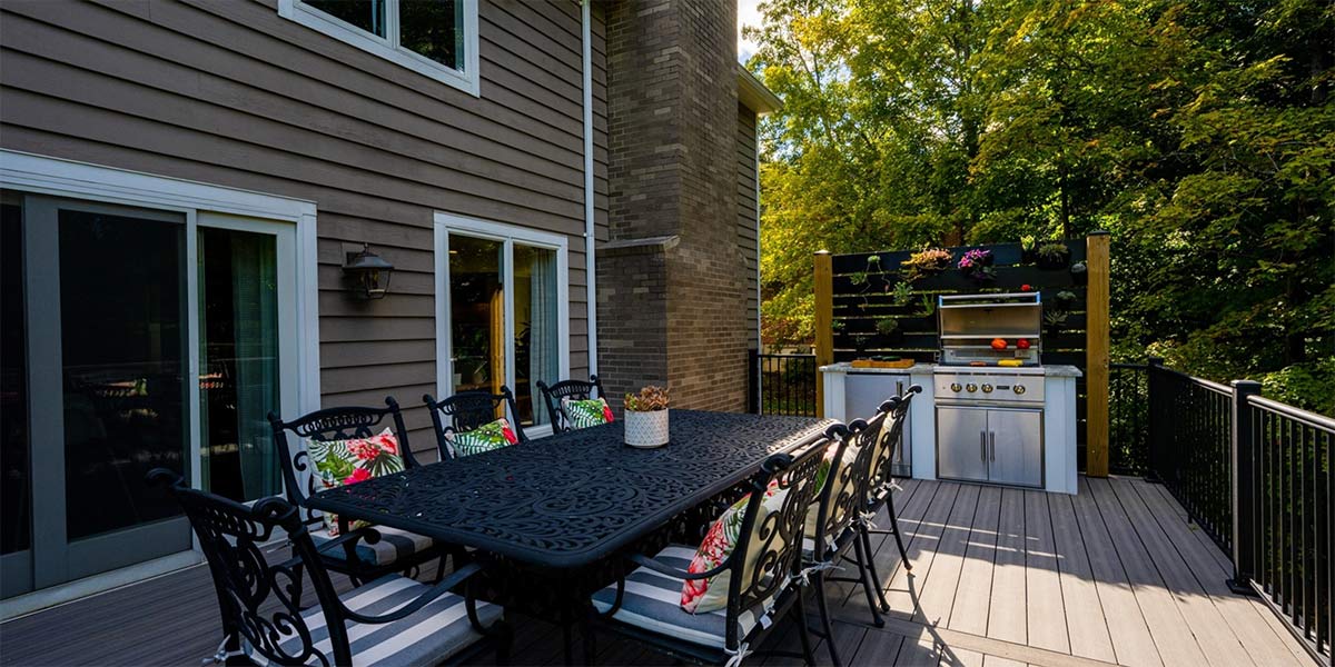 backyard deck with wrought iron dining table and outdoor kitchen that makes sense for the space