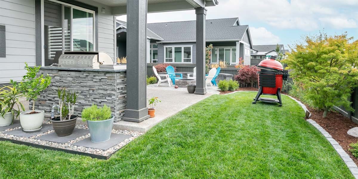 outdoor living area with kamado grill fire pit and outdoor kitchen