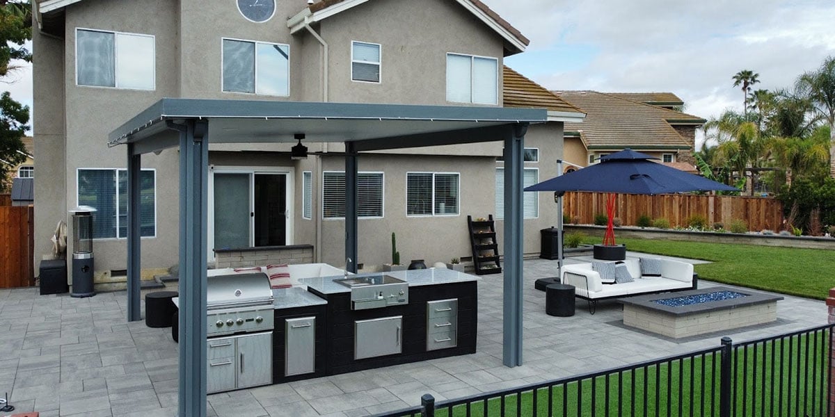 backyard with pavilion outdoor kitchen outdoor sofa and rectangular fire pit