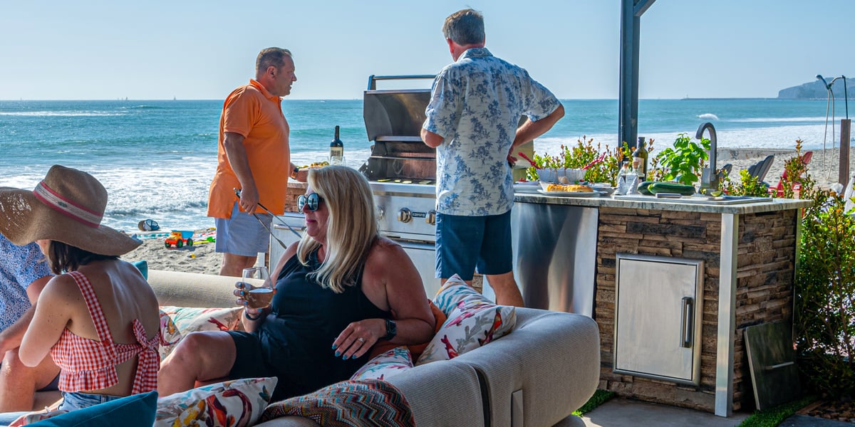 bbq beach party with an outdoor kitchen in view