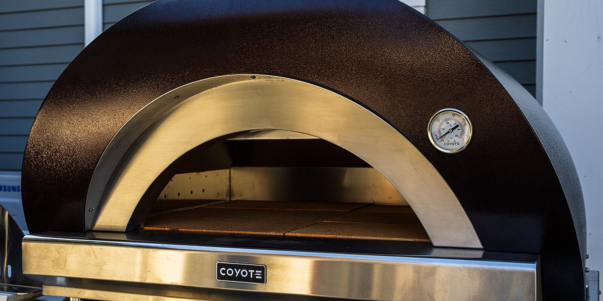 black coyote pizza oven close up on stand
