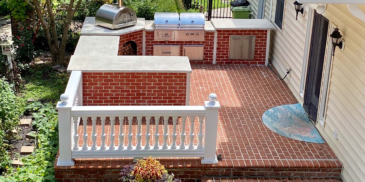 brick patio surface with matching rta u shape outdoor kitchen with grill and pizza oven