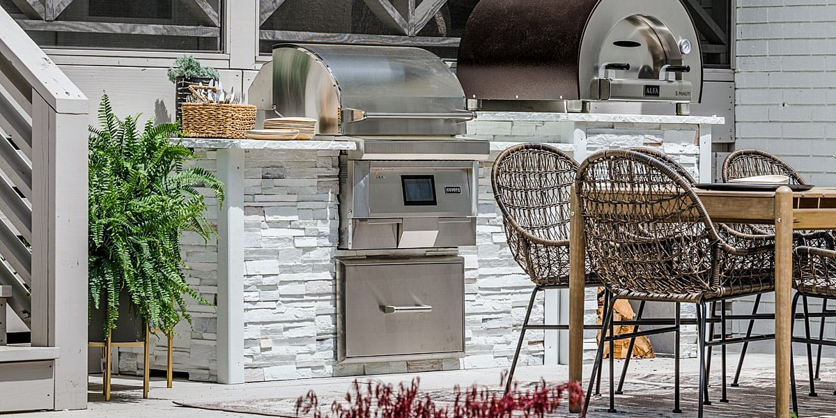built in stainless steel pellet grill with pizza oven in custom outdoor kitchen