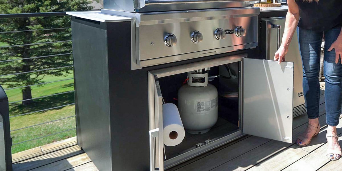 built in gas grill with access door and liquid propane tank underneath