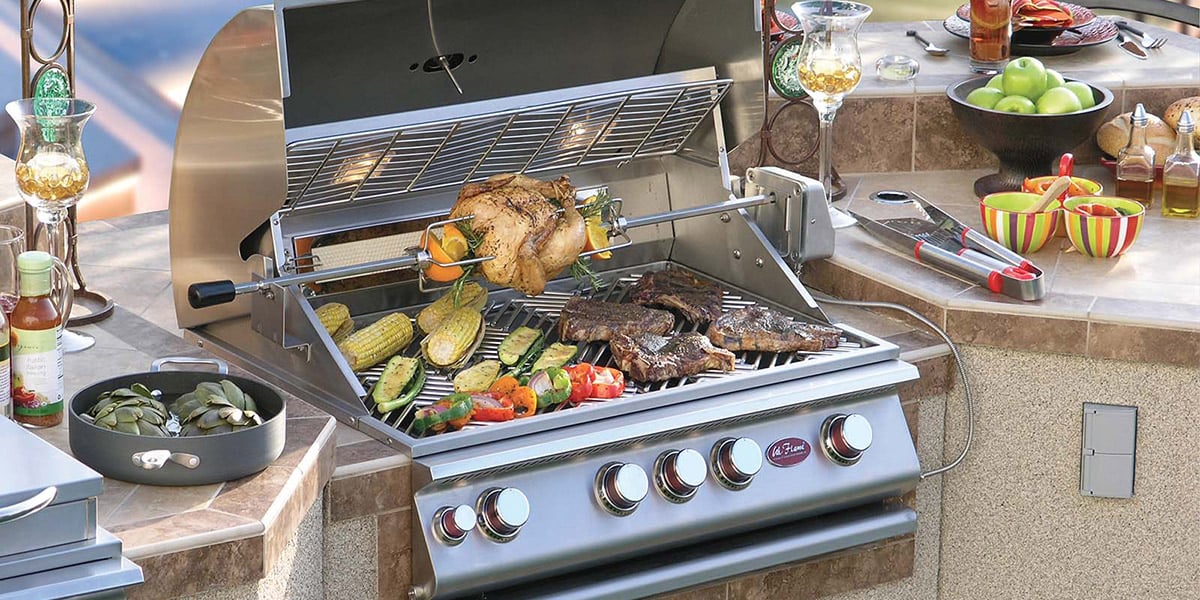 cal flame brand liquid propane gas grill head in outdoor kitchen in the middle of a cook