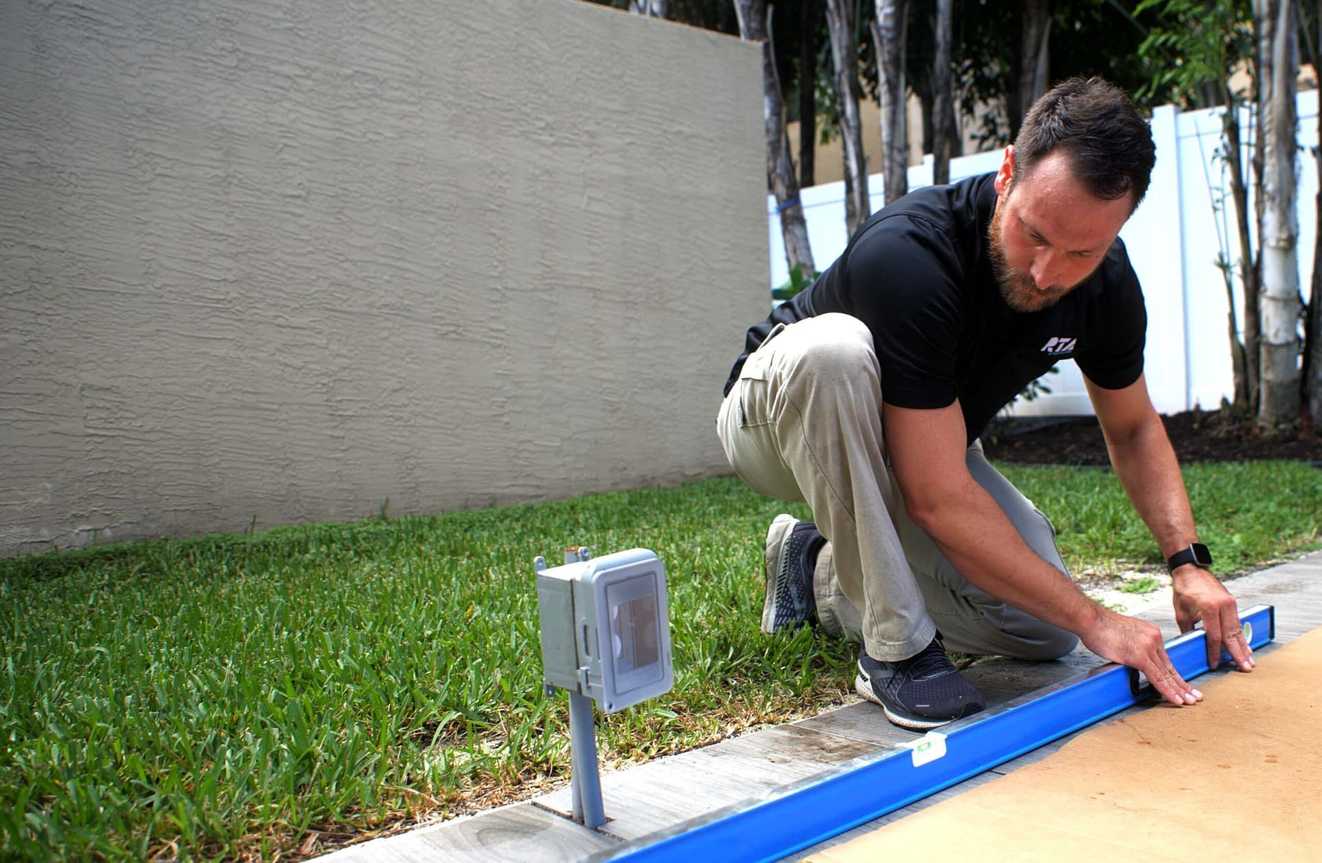 Checking Pitch of Patio for Water Drainage to Prepare for DIY Outdoor Kitchen
