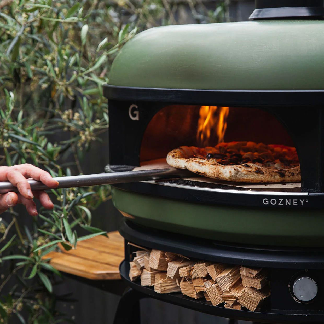 close up of gozney dome with pizza being turned inside