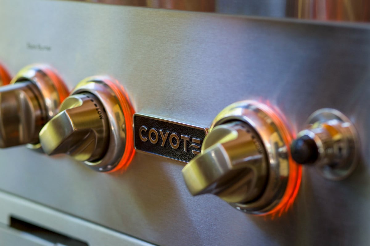 close up of lighting up illuminated knobs on coyote grill model