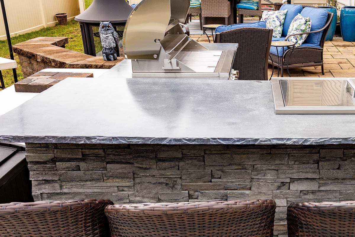 concrete countertop on an rta outdoor kitchen with a built in sink and grill