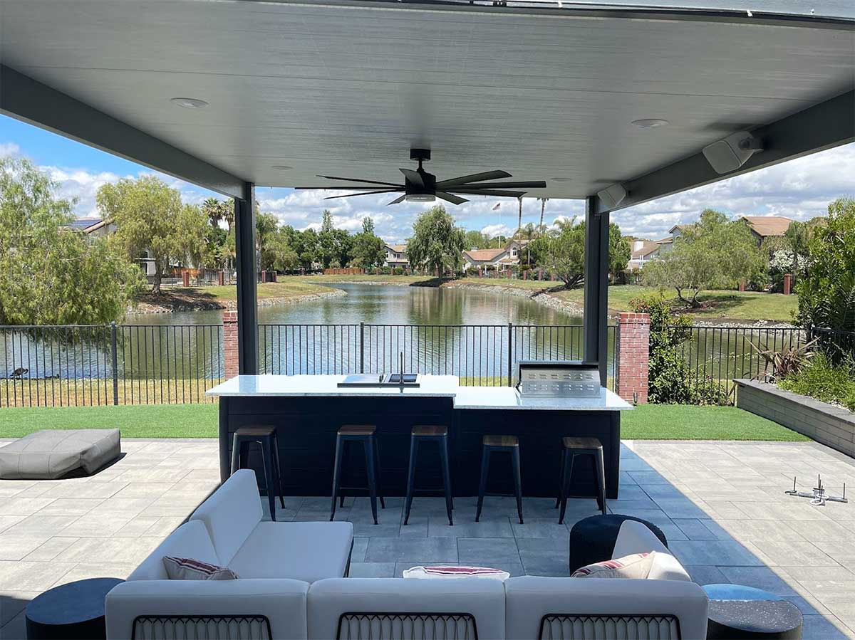 covered bar area with overhead fan and seating location