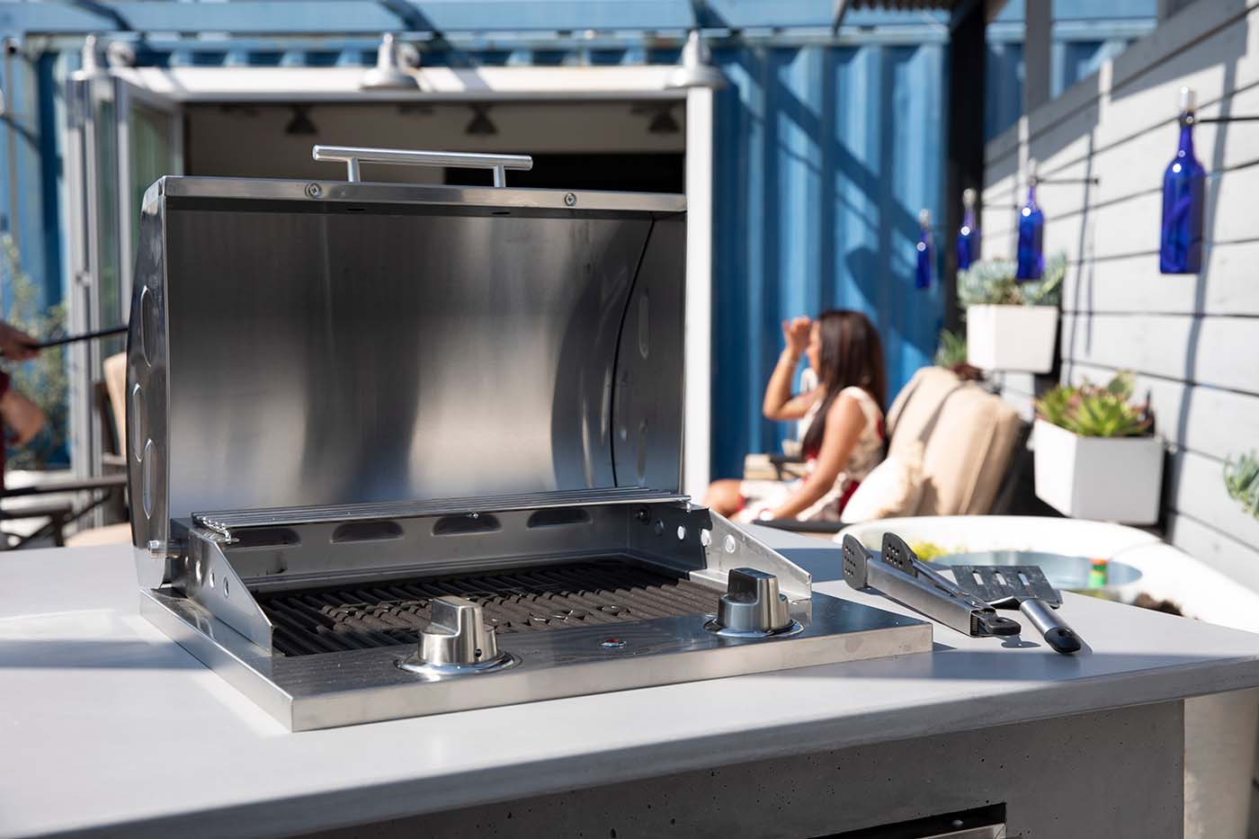 coyote electric grill in a concrete outdoor kitchen on a balcony