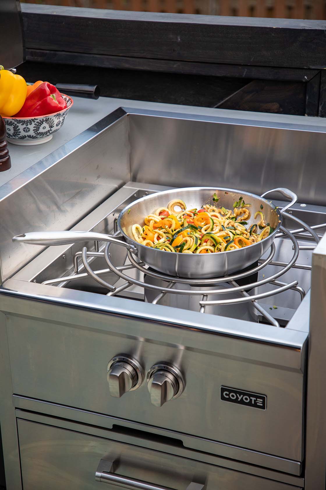coyote power burner with wok accessory cooking some delicious looking food
