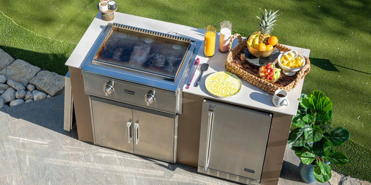 coyote stainless steel flat top grill in outdoor kitchen