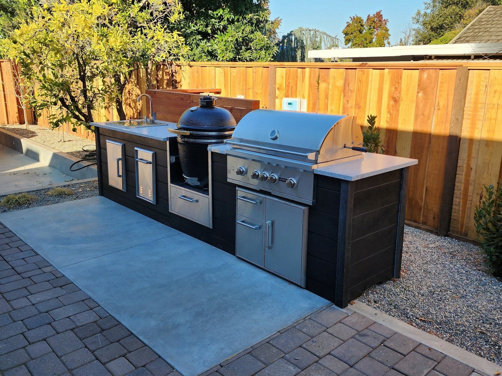 dark plank outdoor kitchen with built in asado cooker