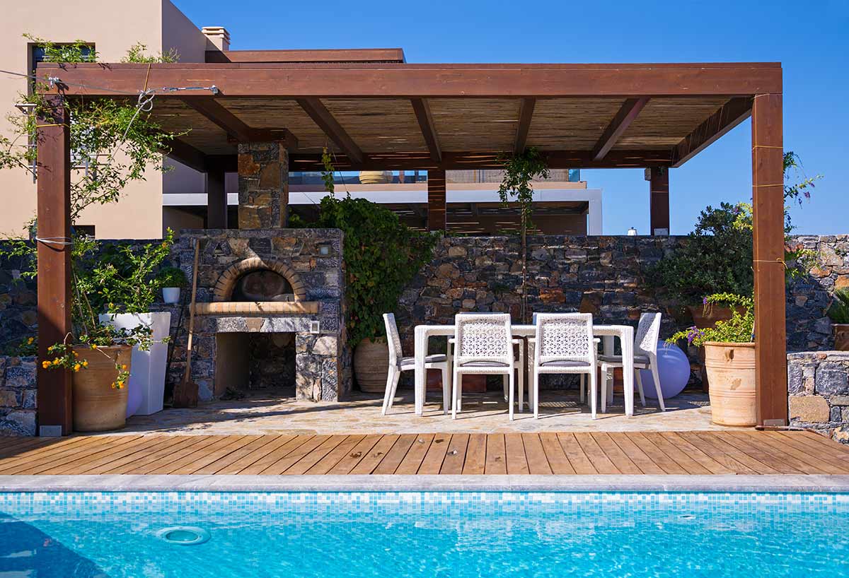 diy pizza oven by pool with seating