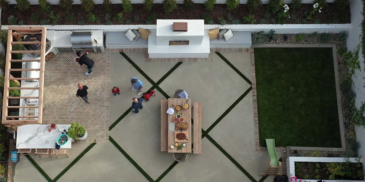 drone shot of patio with multiple surfaces and u shaped rta outdoor kitchen