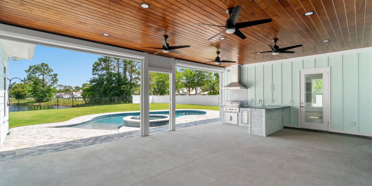extended covered patio with pool and outdoor kitchen