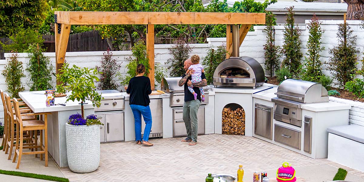 family enjoying day at their outdoor kitchen