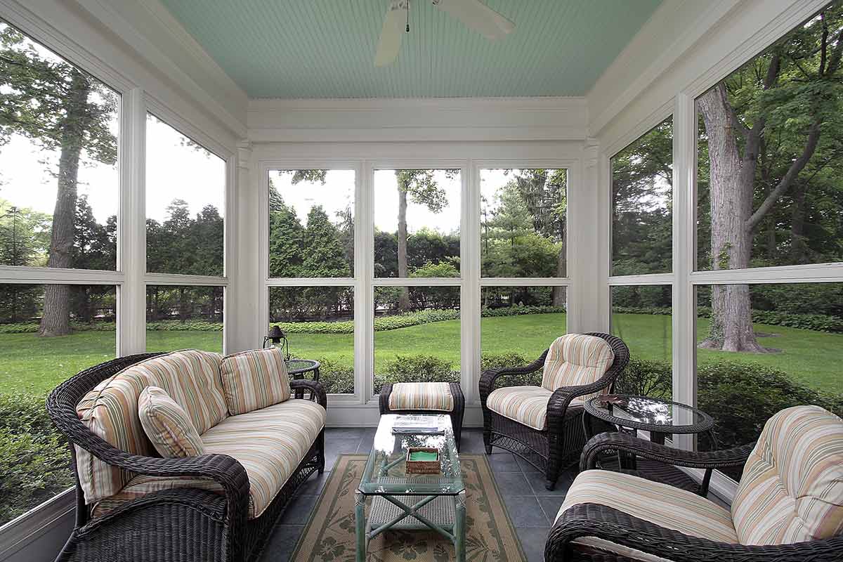 Florida room with outdoor furniture with large windows