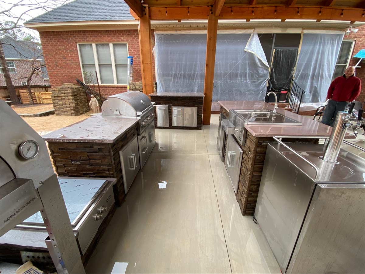 freestanding kegerator next to outdoor kitchen