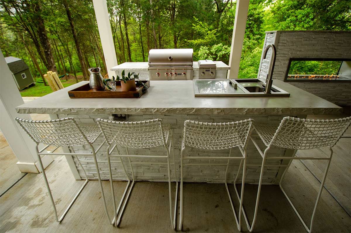 galley outdoor kitchen with bar island and seating