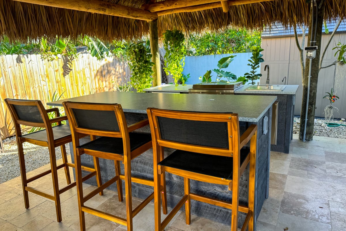 galley outdoor kitchen with chairs and bar island
