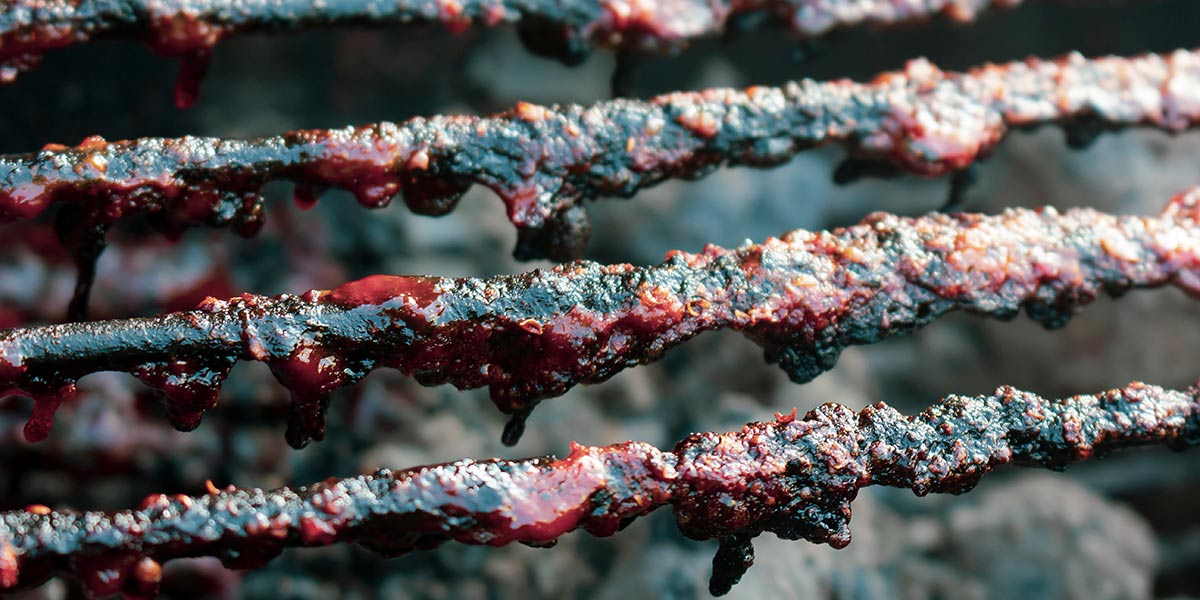 grill grates covered in burned on sticky sauce