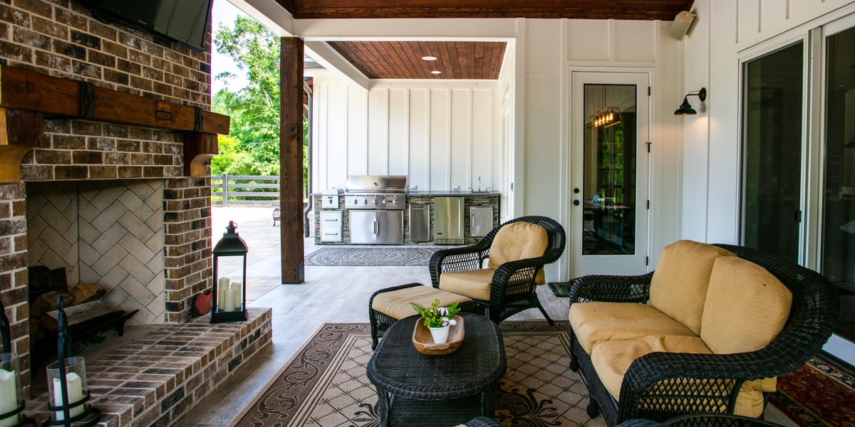 indoor outdoor living space with fire pit lounge area and outdoor kitchen