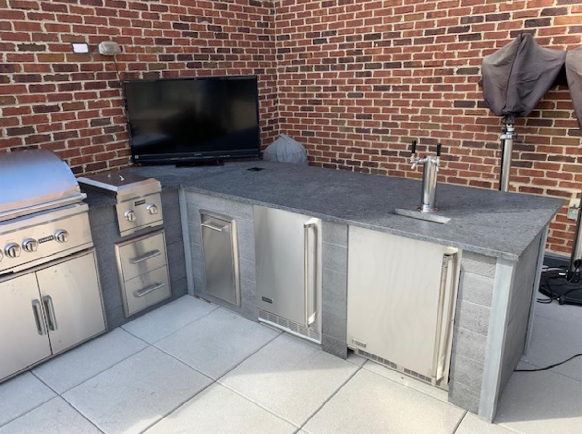 kegerator in rta outdoor kitchen with bar seating on patio