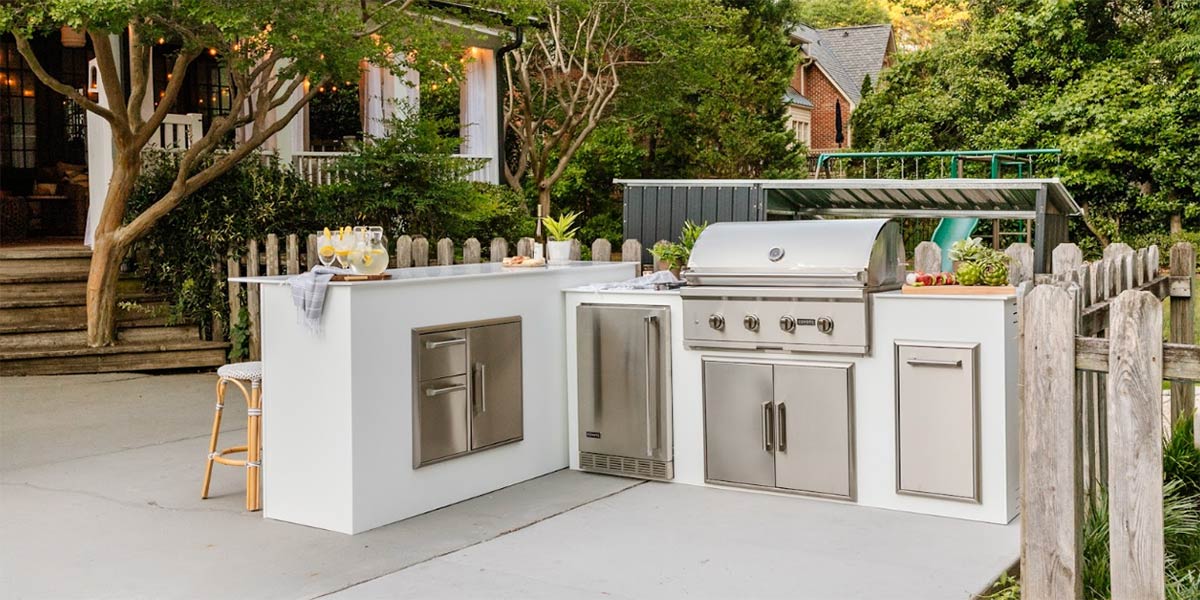 white l shape modular outdoor kitchen on concrete patio pad