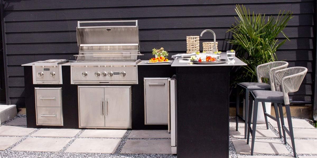L shaped outdoor kitchen on patio with outdoor seating.