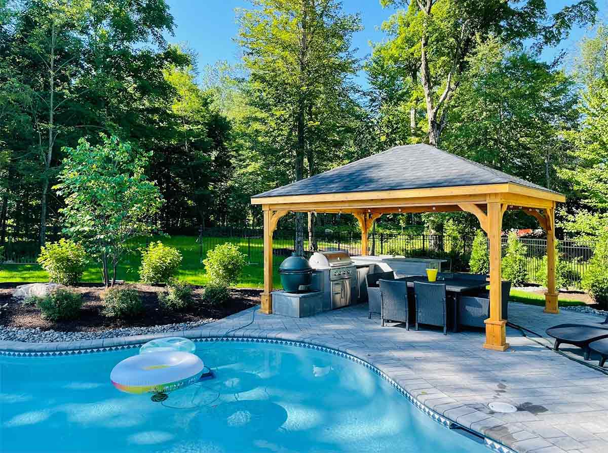 Pool Pavilion with l shaped Outdoor Kitchen equipped with an asado smoker