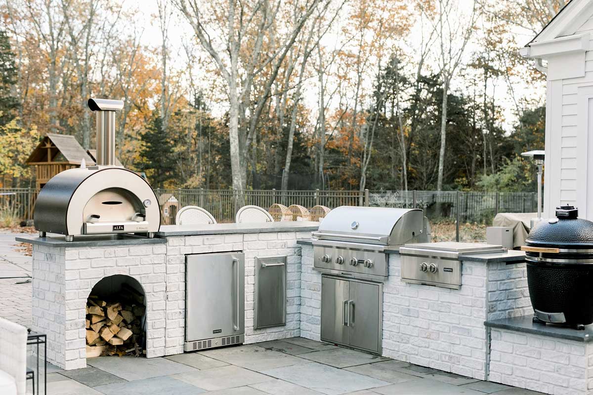 l shaped outdoor kitchen with pizza oven and dual burner