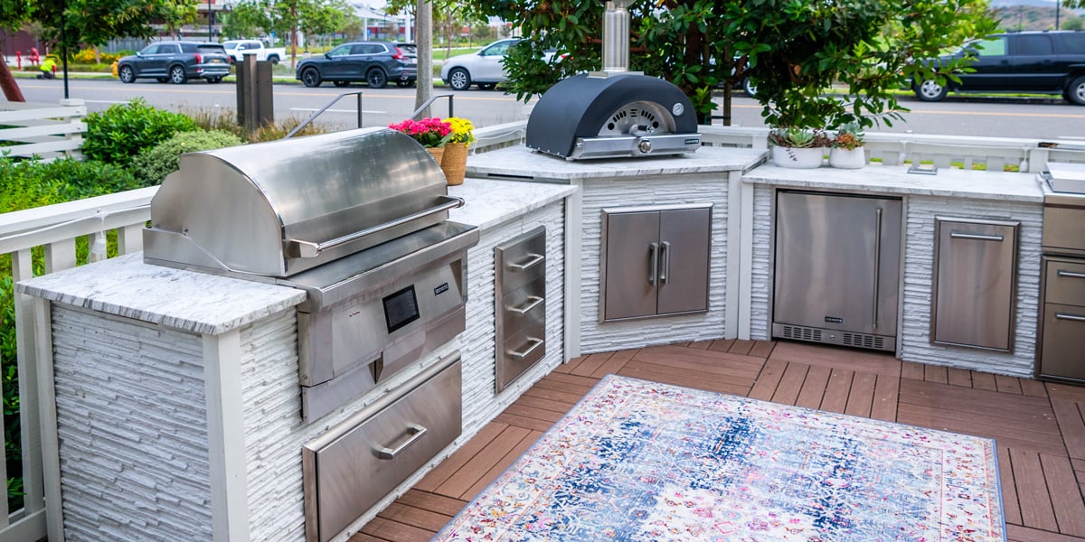 l shaped outdoor kitchen with pizza oven and flat top grill