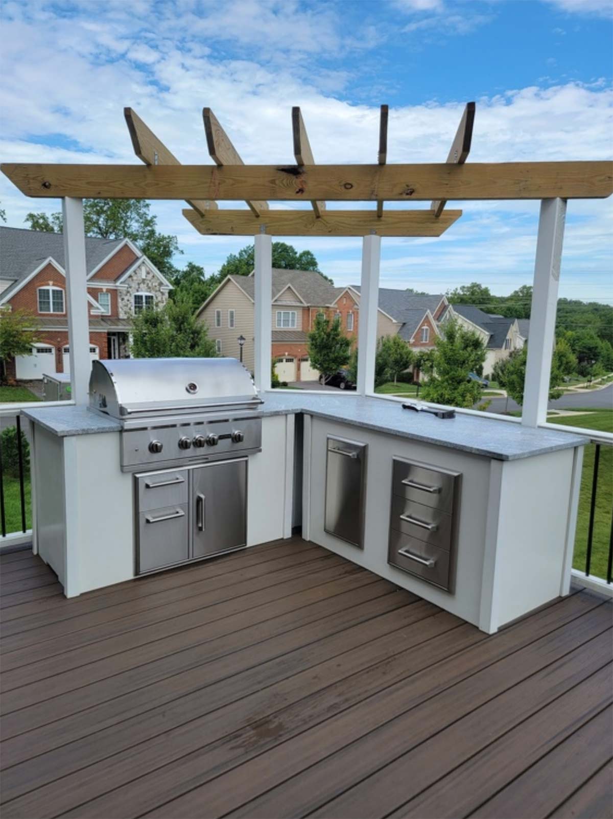 l shaped outdoor kitchen with unique pergola on deck