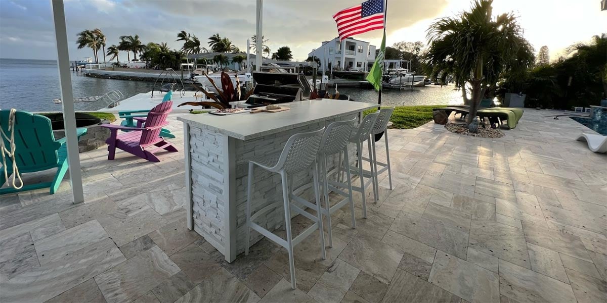 l shaped stacked stone chalk grill island with bar island