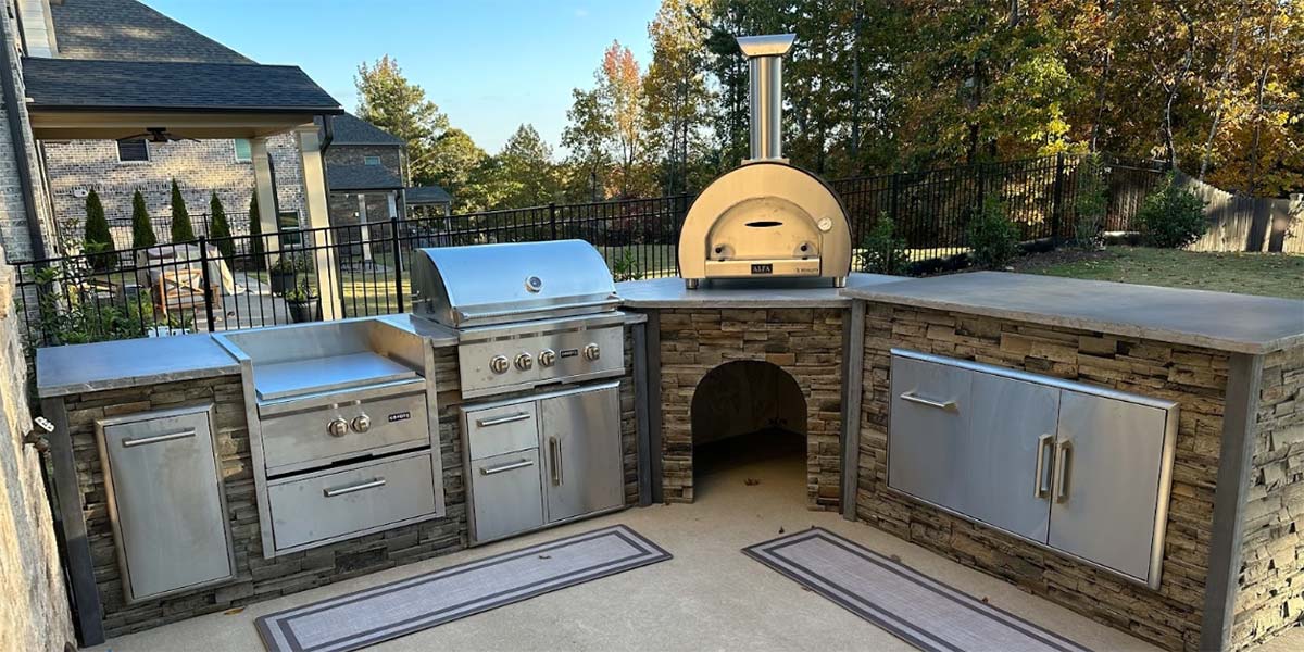 l shaped stacked stone outdoor kitchen with corner island unit
