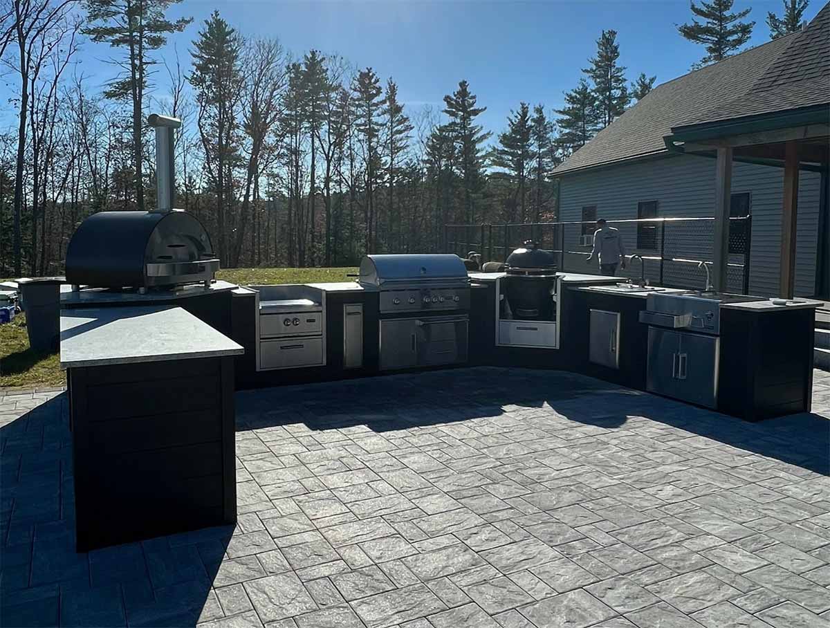 large u shaped outdoor kitchen in plank charcoal on patio with lots of appliances