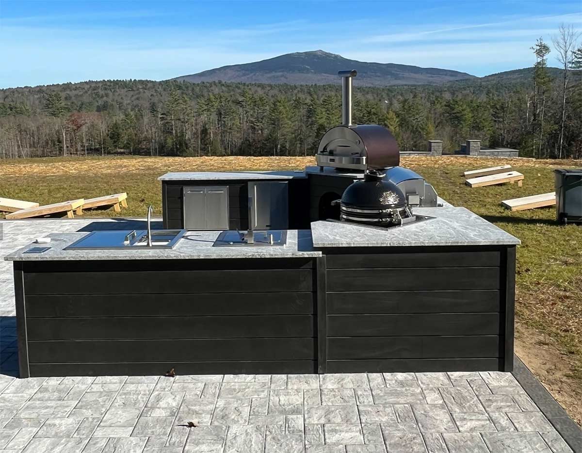 large u-shaped outdoor kitchen on patio overlooking mountain view