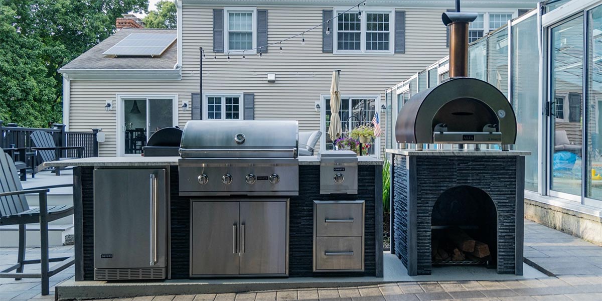 linear grill island with pizza oven on patio in modern stone ash 1