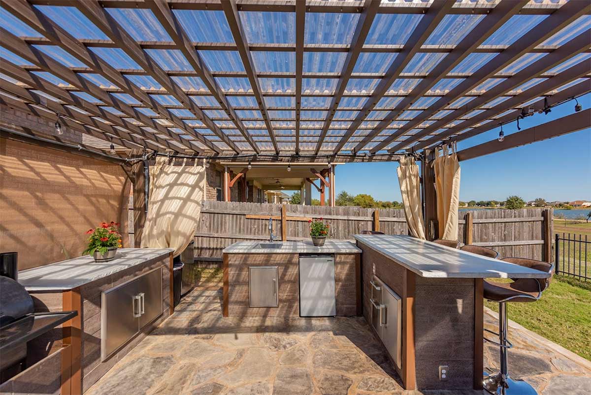 Covered pergola outdoor kitchen with adjustable bar stools