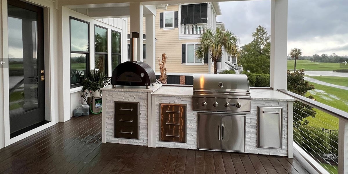 linear outdoor kitchen with gas grill and pizza oven