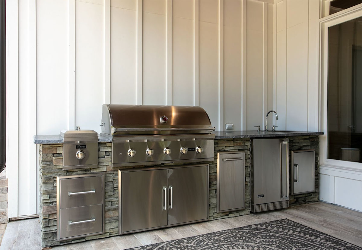linear outdoor kitchen with sink and storage