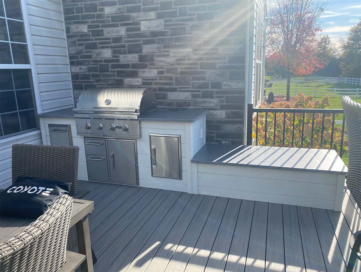 linear outdoor kitchen with stone backsplash