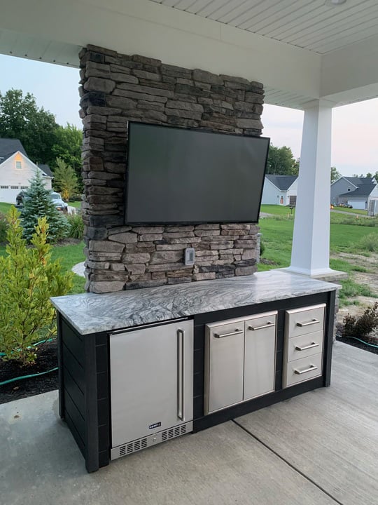 linear refrigerator and storage island on patio with plank charcoal finish